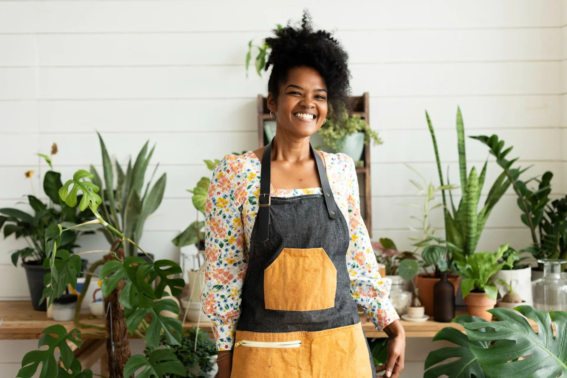 Small business owner smiling in her plant shop