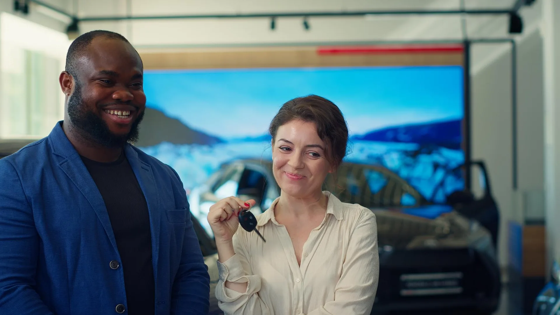Two members celebrating a completed car deal, holding the keys